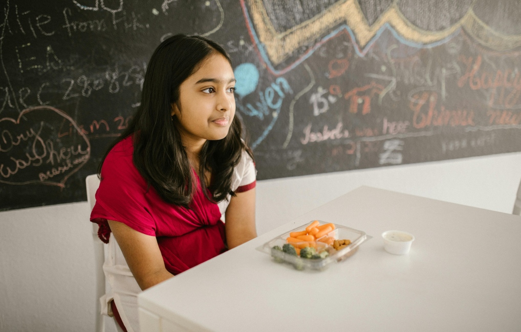 Child eating lunch in a school alone
