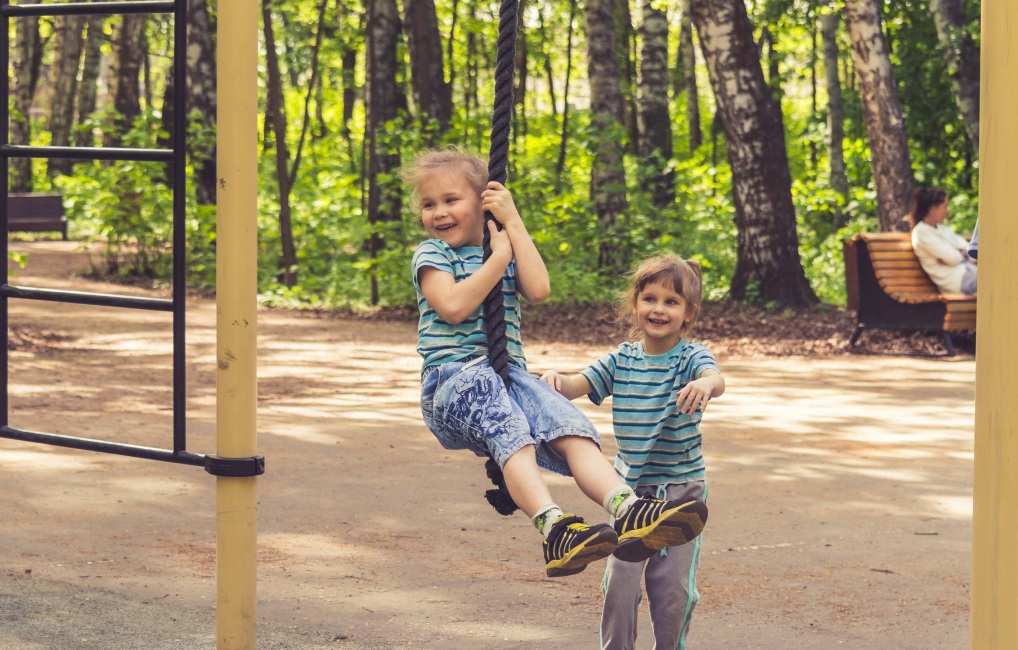 Children climbing a rope outside