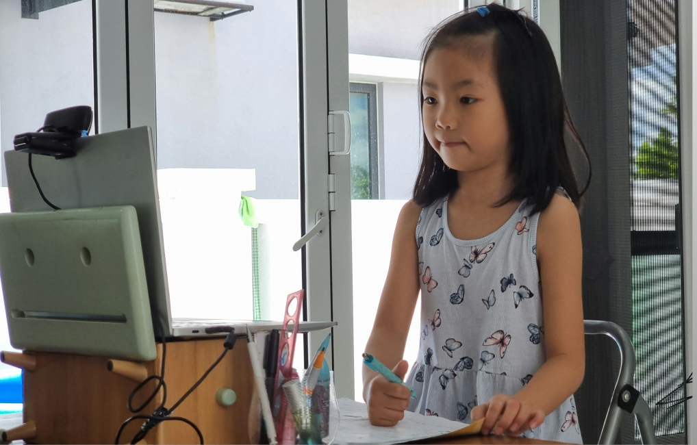 Child sitting at a desk learning
