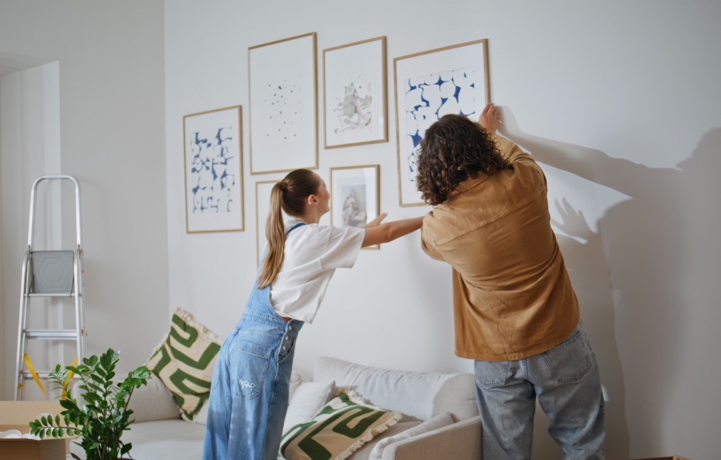 Couple hanging up new artwork
