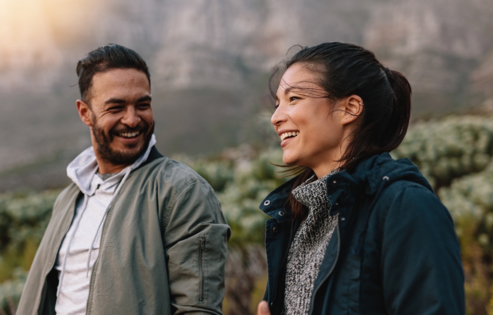 Couple laughing together in the countryside