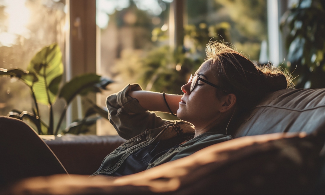 Woman resting her eyes on a sofa