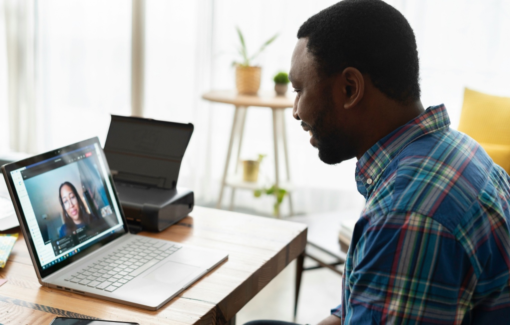 Man video calling a loved one using a laptop