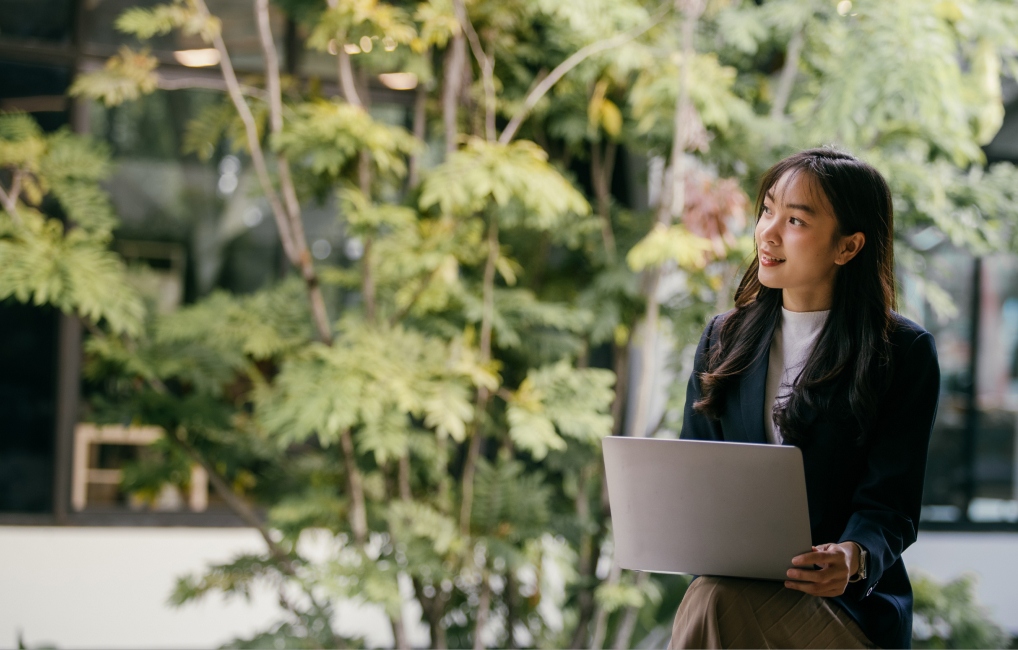 Woman at a laptop outside