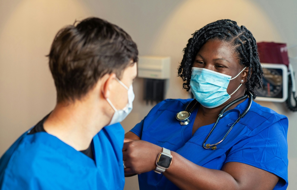 Female nurse and a male nurse with masks on